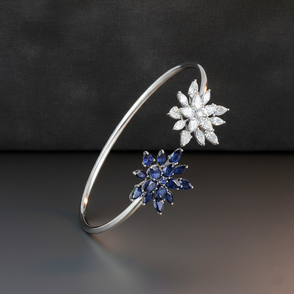 Silver bracelet with diamond and sapphire flower-shaped clasps on a dark background